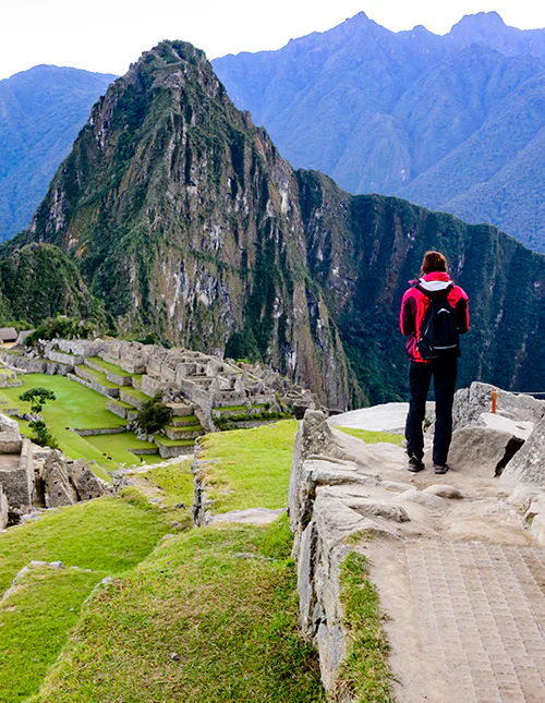 Person står og kigger ud over Machu Picchu